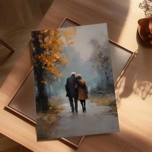 May include: An art print depicting an elderly couple walking arm-in-arm on a path. The painting features a muted color palette with a focus on the couple and the surrounding trees with yellow and orange leaves. The print is framed.