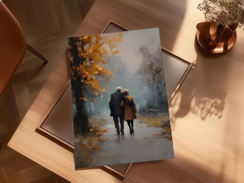 May include: An art print depicting an elderly couple walking arm-in-arm on a path. The painting features a muted color palette with a focus on the couple and the surrounding trees with yellow and orange leaves. The print is framed.