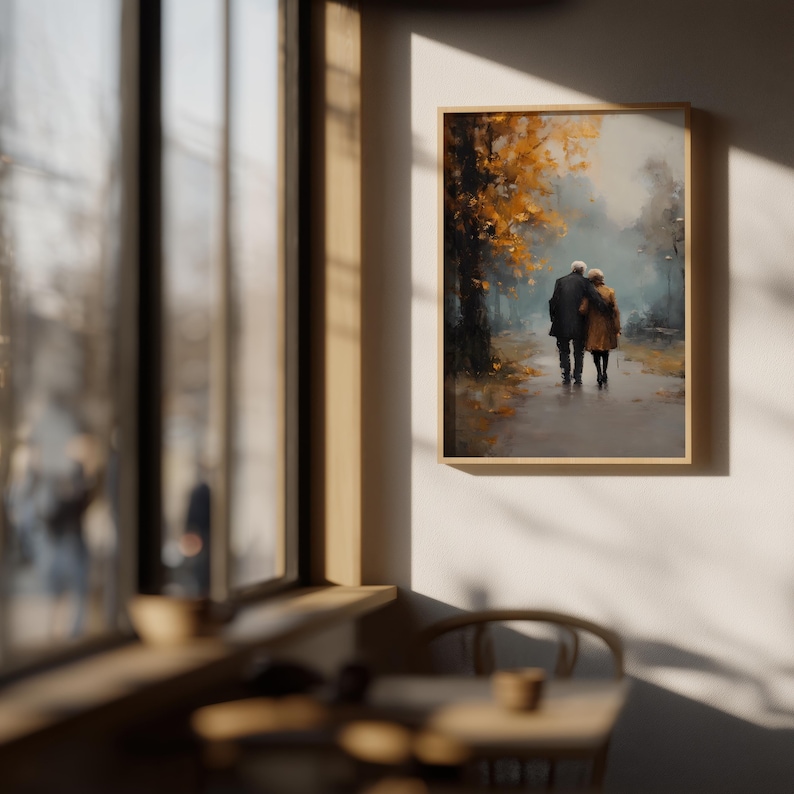 May include: A framed art print depicts an elderly couple walking on a path. The artwork features a muted color palette with shades of brown, orange, and gray, suggesting an autumn scene. The couple is seen from behind, adding a sense of intimacy.