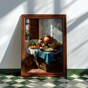 May include: A framed still life painting depicts a rustic table setting. The scene includes pottery, bowls of fruit, and a blue tablecloth. The artwork is in warm tones, with a focus on natural light and shadow.