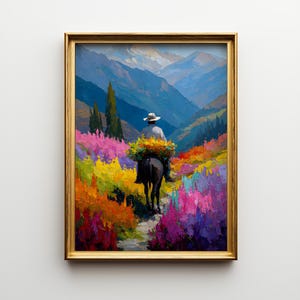 May include: A framed landscape painting depicts a person on a donkey carrying flowers through a vibrant field. The artwork features a palette of bright colors, including pink, yellow, and blue, with a mountain range in the background. The painting is in a gold frame.