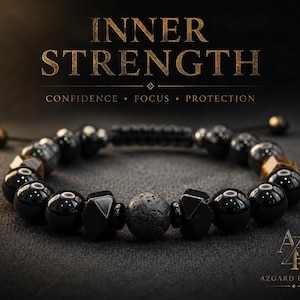 May include: A beaded bracelet featuring smooth black onyx spheres, faceted black beads, and a central porous lava stone bead. The text above reads INNER STRENGTH, CONFIDENCE, FOCUS, PROTECTION, and the logo AZGARD RICHES is in the bottom right corner.