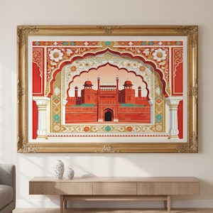 Puede incluir: Una impresión enmarcada que representa un palacio indio con muros rojos y entradas arqueadas. La obra de arte está enmarcada en un marco dorado ornamentado y cuelga sobre una consola de madera. La paleta de colores incluye rojo, dorado, blanco y turquesa.