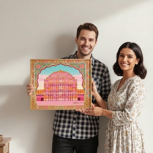 May include: A framed art print featuring a colorful illustration of a palace with pink and blue hues. The artwork is held by two people, showcasing the intricate details and vibrant colors of the architectural design. The frame has a gold border.