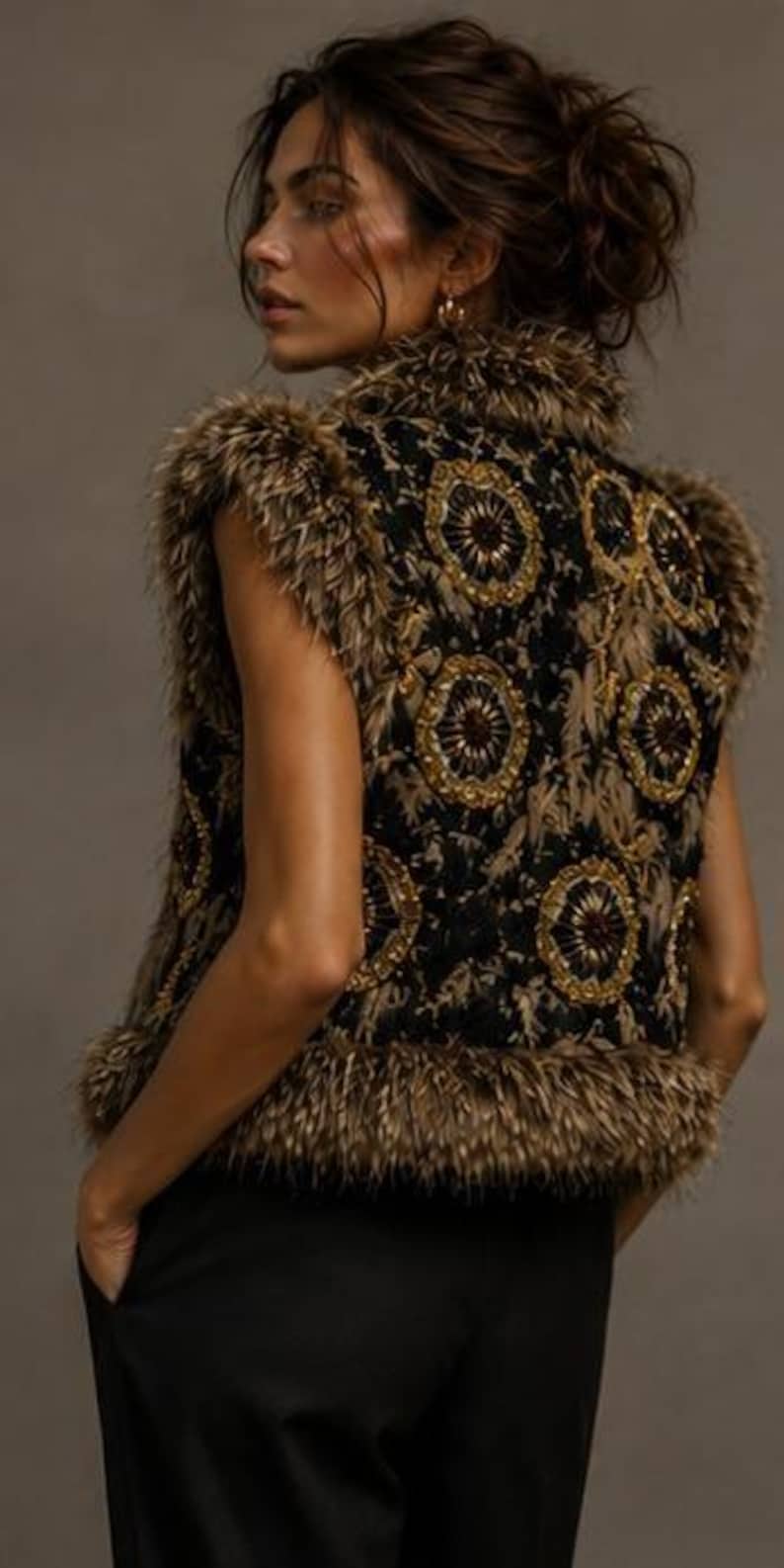 May include: A sleeveless vest featuring a black base with intricate gold and brown circular embroidery patterns. The garment is trimmed with thick, textured brown faux fur along the collar, armholes, and hemline, providing a layered appearance.