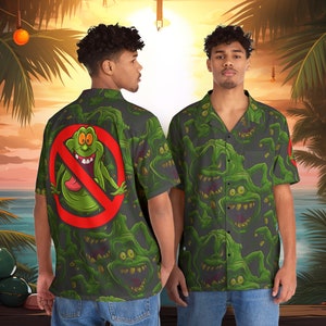 May include: A dark gray short-sleeved button-up shirt with a green and white pattern of cartoon ghosts. The back of the shirt features a large red circle with a diagonal line through it and a green cartoon ghost inside.