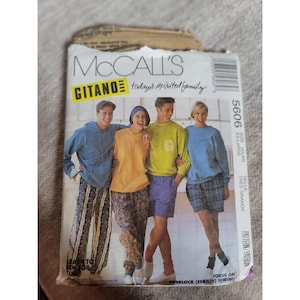 May include: A vintage McCall's sewing pattern titled "GITANO" featuring a group of people wearing casual clothing. The pattern includes sizes for extra large. The cover has text that says "Learn to sew for fun" and "Focus on overlock sewing".