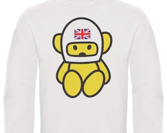 May include: White sweatshirt featuring a cartoon character with a yellow body and a helmet adorned with the Union Jack. The character has a black outline and is in a seated position. The sweatshirt has a crew neck and long sleeves.
