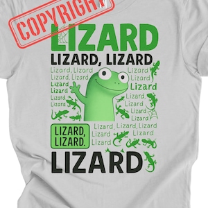 May include: White t-shirt with a green lizard graphic. The word "LIZARD" is displayed in large green letters, with smaller text and lizard illustrations surrounding a cartoon lizard character. A red "COPYRIGHT" stamp is in the upper left corner.