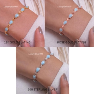 May include: A bracelet featuring a series of light blue, teardrop-shaped stones linked together. The set includes three variations: one with 18K gold plating, one with rose gold plating, and one made of 925 sterling silver, each labelled accordingly.