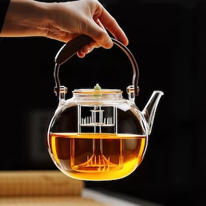 May include: A set of three ceramic mugs with a speckled, matte finish in cream, light grey, and dark grey. Each mug has a simple, minimalist design, ideal for coffee or tea.