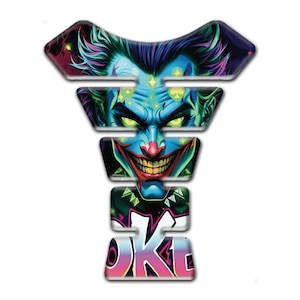 May include: A motorcycle tank protector with a vibrant, detailed graphic of a clown's face. The design features a blue face, green hair, and a red nose, with the word "JOKE" in colorful graffiti-style lettering.