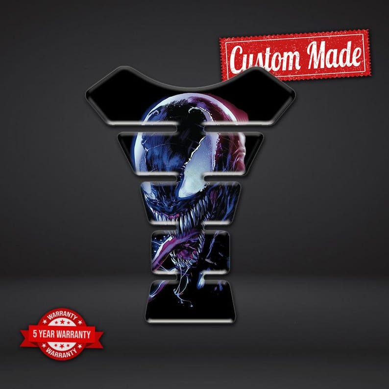 May include: A black and multi-colored graphic of Venom, a comic book character, on a motorcycle tank protector. The tank protector has a unique shape and the words "Custom Made" are in the upper right corner.
