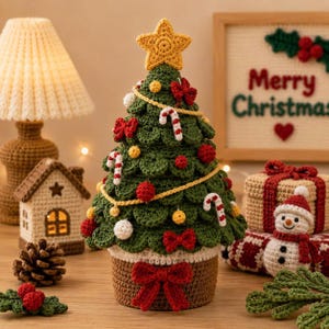 May include: A crocheted Christmas tree decoration featuring a dark green tiered design, a yellow star topper, and red bows. It is adorned with small red and white spheres, candy cane motifs, and a yellow garland, set in a brown crocheted pot.