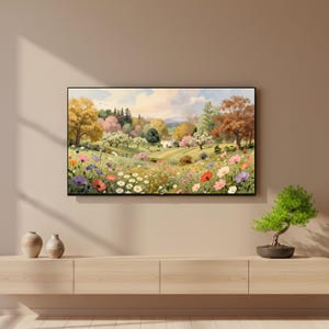 May include: A rectangular wall art print featuring a landscape painting of a rolling meadow filled with colorful wildflowers, including red, white, and purple blossoms, leading toward a small house nestled among trees under a soft, cloudy sky.