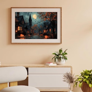 May include: A framed Halloween-themed painting depicts a spooky village scene under a full moon. The artwork features illuminated houses, jack-o'-lanterns, and autumn trees in shades of orange, brown, and black, creating a festive atmosphere.