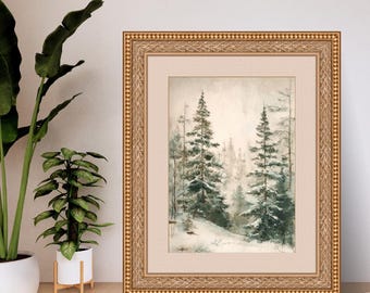 Puede incluir: Pintura de acuarela enmarcada de una escena de bosque nevado. La obra presenta altos árboles de hoja perenne cubiertos de nieve, sobre un fondo brumoso de tonos neutros. La pintura está enmarcada en un marco dorado adornado con un passe-partout crema.