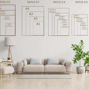 May include: A room interior with a beige sofa, a wooden floor, and a white wall. The wall displays print size guides in inches and centimeters, including 16x24in, 12x18in, 8x12in, and 4x6in. A floor lamp and plants are also visible.