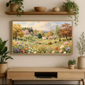 May include: A rectangular landscape painting featuring a rolling meadow filled with colorful wildflowers in shades of pink, red, orange, and purple. A small white house sits in the distance among lush green trees and autumn-toned foliage.