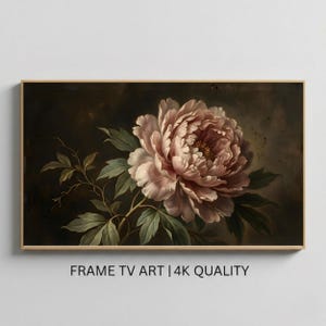 May include: A framed floral print featuring a large, light pink peony with green leaves and stems against a dark background. The artwork is in a gold frame and includes the text "FRAME TV ART | 4K QUALITY".