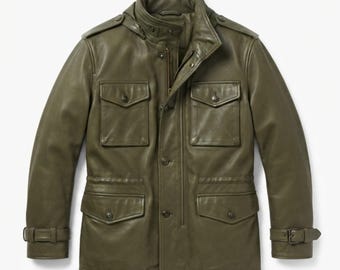 May include: An olive green leather field jacket featuring a high collar, a front zip closure with a snap-button placket, four front flap pockets with snap buttons, shoulder epaulets, and adjustable buckled straps at the sleeve cuffs.