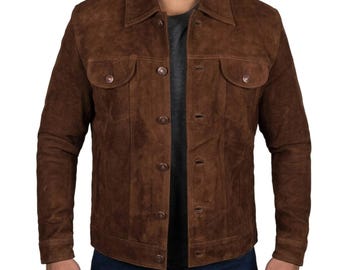 May include: A brown suede jacket with a button-up front, two chest pockets, and a collared neckline. The jacket has a classic design and a slightly worn appearance.