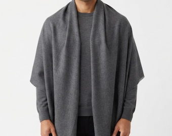 May include: A charcoal grey rectangular scarf with a smooth, fine-knit texture and subtle fringe detailing along the bottom edges. The scarf is draped over the shoulders, featuring a solid, uniform colour throughout the entire fabric surface.
