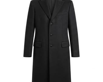 May include: A solid black overcoat featuring a structured collar, notched lapels, and a single-breasted front closure with three fabric-covered buttons. The coat includes two side flap pockets and a single chest pocket on the left side.