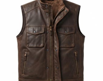 May include: A dark brown leather waistcoat featuring a stand-up collar, a central zip fastening, and a press-stud placket. The garment includes two chest pockets with press-stud flaps and two lower vertical zipped pockets, all finished with tonal stitching.