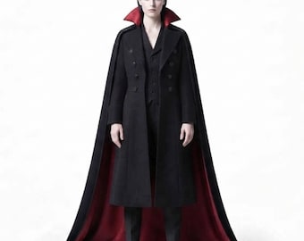 May include: A long black coat featuring a high collar with a red interior lining, double-breasted button closures, and an integrated floor-length cape. The garment is worn over matching black trousers and black boots, creating a structured silhouette.