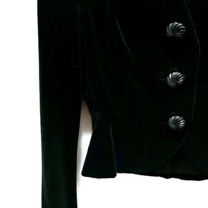 May include: A black velvet blazer with three decorative buttons.