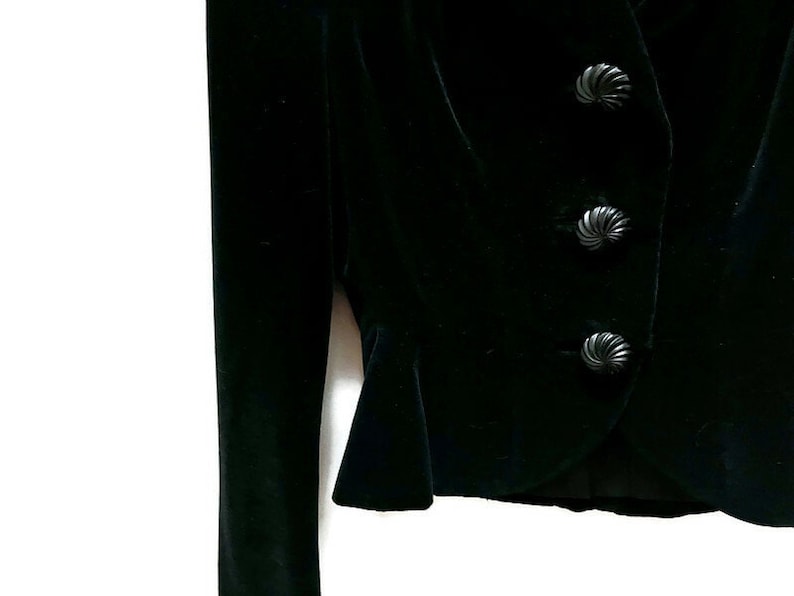 May include: A black velvet blazer with three decorative buttons.