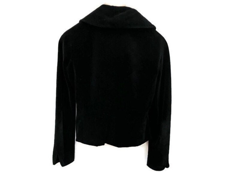 May include: A black velvet blazer with a wide collar and long sleeves.