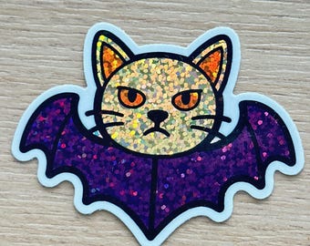 Grumpy Cat Bat Sticker – Glitter finish & durable vinyl. Perfect for laptop, water bottle or as a spooky-cute Halloween gift.