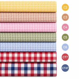 May include: Seven stacked rolls of fabric featuring a gingham check pattern in yellow, tan, pink, green, light blue, red, and a red-and-blue combination. Each roll is labeled with a circular color code icon labeled C2, C3, C4, C5, C6, CT7, and CT47.