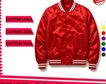 May include: A bright red varsity jacket featuring a button-front closure, two side pockets, and white striped ribbed trim on the collar, cuffs, and hem. The jacket has a smooth, satin-like finish and includes text reading CUSTOM LOGO, CUSTOM LABEL, and CUSTOM TAGS.