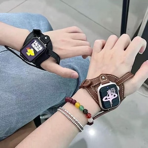 May include: Two smartwatches with leather wristbands. One is black, the other is brown. The watch faces display the time, 14:29, and a graphic. A beaded bracelet and a silver bracelet are also visible.