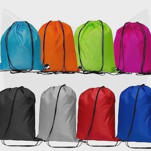 May include: Eight drawstring bags in a range of colours: blue, orange, green, pink, black, grey, red, and royal blue. Each bag features a black drawstring closure and a simple design. The bags are arranged in two rows of four.