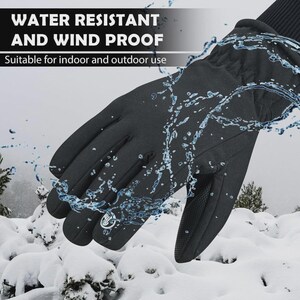 May include: Black gloves with the text "WATER RESISTANT AND WIND PROOF" and "Suitable for indoor and outdoor use". The gloves have a textured palm and are being splashed with water. The background shows snow-covered ground and trees.