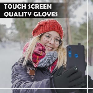 May include: Black touch screen gloves with a white logo on the palm. The gloves are being used to operate a smartphone. The image also shows a person wearing a red hat, glasses, and a scarf. The text "TOUCH SCREEN QUALITY GLOVES" is at the top.