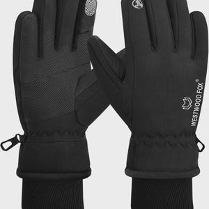 May include: Black gloves with a textured palm and fingertip design. The gloves have a ribbed cuff and a zipper detail. The brand name "WESTWOOD FOX" is printed in white on the side. The gloves are designed for touchscreen use.