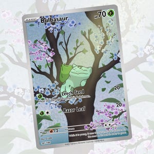 May include: A Bulbasaur Pokémon trading card featuring a green Bulbasaur character resting on a tree branch. The card has a light blue background with flowering branches and the text "Bulbasaur", "Leech Seed", and "Razor Leaf".
