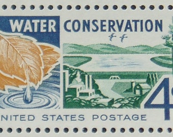 May include: A vintage 4-cent United States postage stamp with the text "WATER CONSERVATION" in blue lettering. The stamp features a brown leaf with a water droplet falling from it, a blue river, and a green dam.