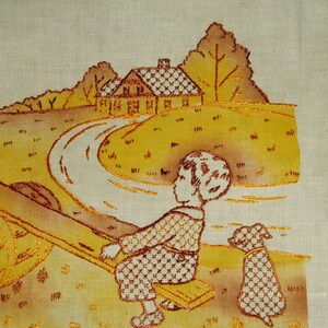 May include: A beige fabric panel featuring an embroidered scene in shades of yellow and brown. The design depicts a child sitting on a seesaw with a small dog nearby, set against a landscape with a house, trees, and a winding path.