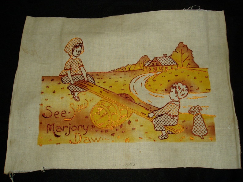 May include: A rectangular piece of off-white fabric featuring an embroidered scene of two children on a seesaw with a dog, a house, and trees in the background. The text "See-Saw Marjory Daw..." is embroidered in brown thread on the left side.