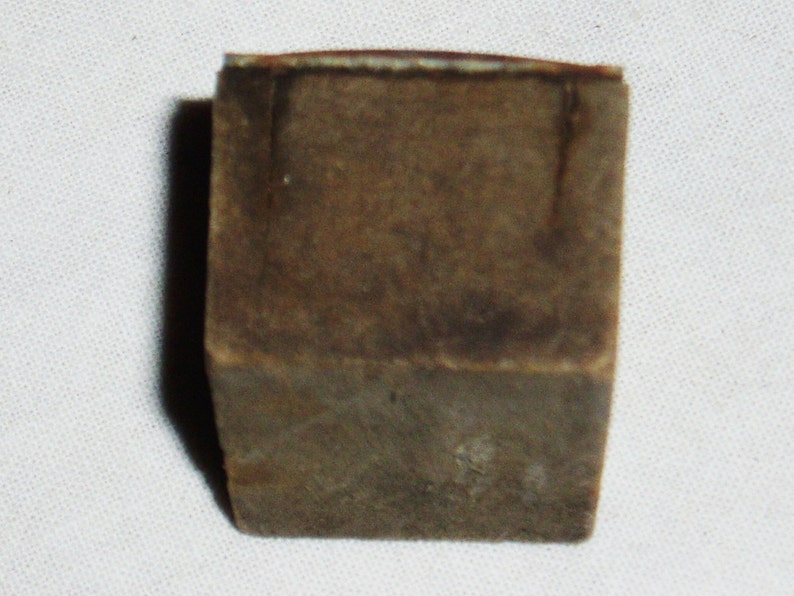 May include: A small, square, brown, wooden box with a slightly worn surface.