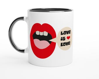 May include: A white ceramic mug with a black handle and rim. The mug features a graphic of red lips with the words "Love is Love" in a speech bubble. The design includes a red heart symbol.