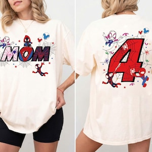 May include: Cream-colored t-shirt featuring a Spider-Man theme. The front displays the word "MOM" with a spider web design and cartoon Spider-Man characters. The back shows a large red number "4" with a spider web design and more Spider-Man characters.