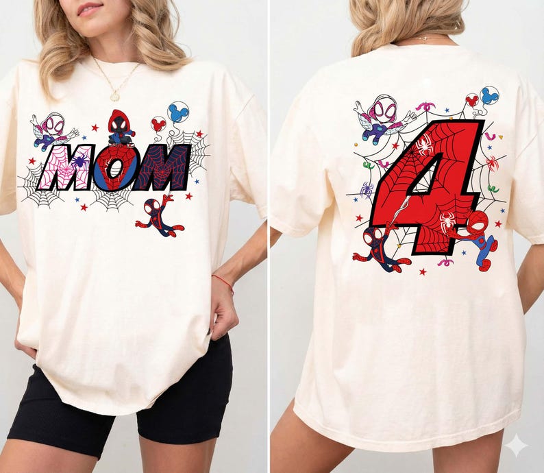May include: Cream-colored t-shirt featuring a Spider-Man theme. The front displays the word "MOM" with a spider web design and cartoon Spider-Man characters. The back shows a large red number "4" with a spider web design and more Spider-Man characters.