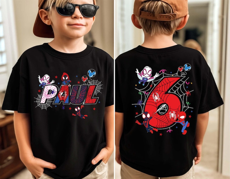 May include: Black t-shirt featuring a colorful Spider-Man design. The front displays the name "PAUL" in a webbed font with Spider-Man characters. The back shows a large red number "6" with a web design and more Spider-Man characters.